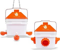 two orange and white birdhouses sitting next to each other