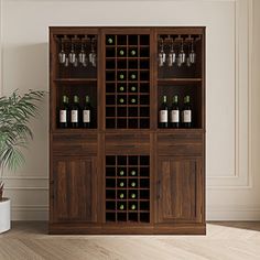 a wooden cabinet with wine bottles and glasses on it in front of a potted plant