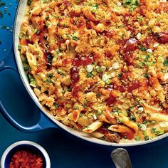 a casserole dish with meat, cheese and vegetables in it on a blue plate