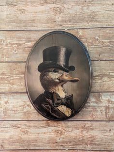 a painting of a duck wearing a top hat and bow tie on a wooden wall