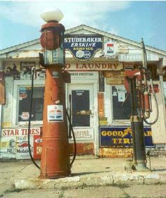 an old fashioned gas pump in front of a building