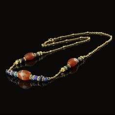 Roman Empire Necklace with Glass and Carnelian Beads 🏺✨ This exquisite necklace combines authentic Roman glass beads with beautifully faceted Carnelian stones, rethreaded with modern gold-plated spacers and a Jasseron chain for an elegant finish. The rich hues of blue glass and the fiery orange-red of Carnelian create a stunning contrast that captures the essence of Roman craftsmanship. Ancient Carnelian, a highly prized stone in the Greco-Roman era, was believed to possess magical properties, Ancient Roman Jewelry, Roman Jewelry, Roman Era, Empire Romain, Greco Roman, Roman Soldiers, Roman Glass, Carnelian Stone, Carnelian Beads