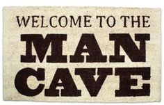 a welcome mat that says, welcome to the man cave in black and white letters