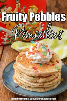 a stack of fruity pebbles pancakes with whipped cream and sprinkles on top