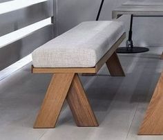 a wooden bench sitting in the middle of a room