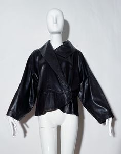 Black leather jacket. Peplum style. Collared. Wide arms. Lined. Leather. Made in Italy.  *Condition: Excellent vintage condition. No visible Flaws. Measurements Taken Laying Flat (inches)-- Shoulder to Shoulder: 17 in. Sleeve Length:  24 in. Bust: 36 in. Waist: 32 in. Length: 25 in. Marked Size: 46 IT, best fit for a 8/10 US. Classic Long Sleeve Leather Jacket For Evening, Designer Leather Jacket For Evening In Fall, Fall Leather Jacket With Long Sleeves For Evening, Long Sleeve Leather Jacket For Fall Evenings, Fall Evening Long Sleeve Leather Jacket, Elegant Long Sleeve Biker Jacket For Evening, Designer Leather Evening Outerwear, Peplum Leather Jacket, Dior Skirt