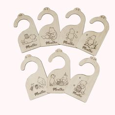 six wooden baby bibs with winnie the pooh characters on them