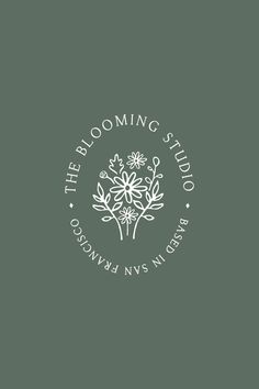 the blooming studio logo on a dark green background with white flowers and leaves in the center