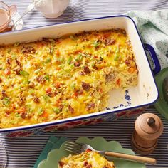 a casserole dish with meat and vegetables in it on a blue and white table cloth