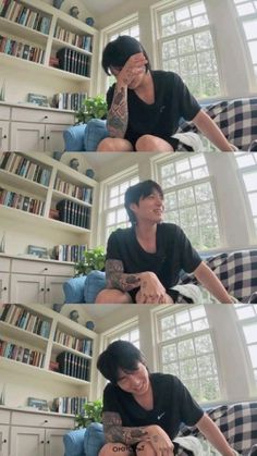 a man sitting on top of a blue couch in front of a book shelf filled with books