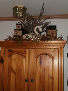 a wooden cabinet with decorations on top of it