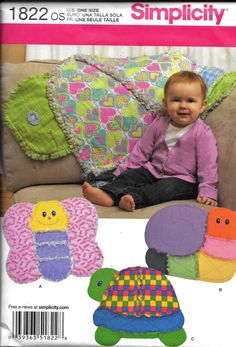 a baby sitting on top of a couch next to pillows and stuffed animals in different colors