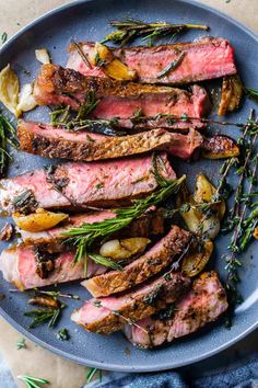 steak with herbs and potatoes on a blue plate