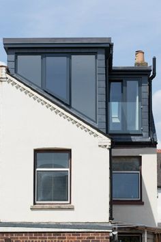 a white house with black roof and windows