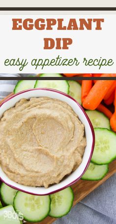 an eggplant dip in a bowl surrounded by cucumbers and carrots