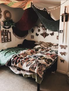 a bed sitting in a bedroom next to a wall with pictures hanging on the walls