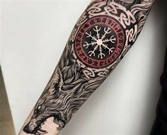 a man's arm with an intricate tattoo design on the forearm and hand,