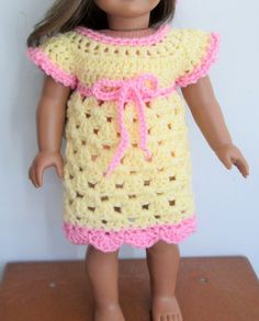 a doll is wearing a crocheted dress