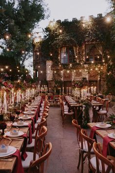 an outdoor dining area with tables and chairs, lit by string lights in the background