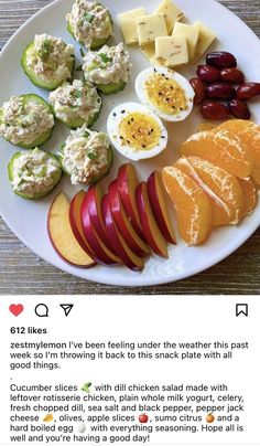 a white plate topped with fruit and veggies on top of a wooden table