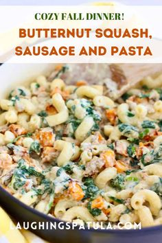 a bowl filled with pasta and spinach covered in cheese