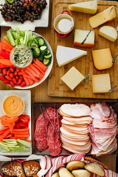 an assortment of cheeses, meats and vegetables on a table