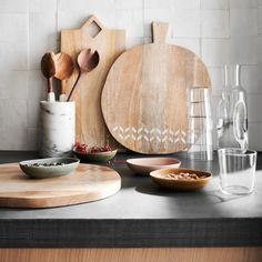 kitchen counter with cutting boards, bowls and utensils