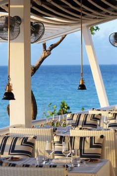 an outdoor dining area overlooking the ocean