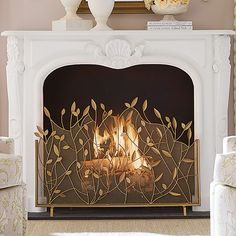 a fire place in a living room filled with furniture and flowers on top of it