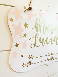 a wooden sign with stars and writing on it