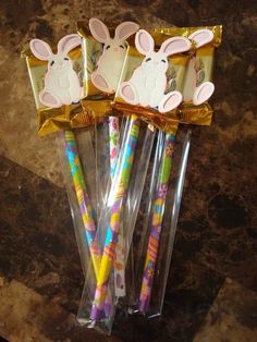 three bunny shaped candy sticks in plastic wrappers