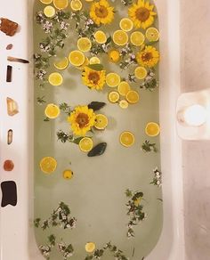 a bathtub filled with lots of lemons and flowers