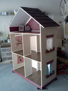 the doll house is made out of cardboard