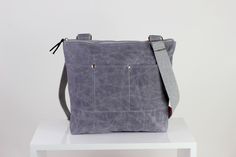 $45 Gray waxed tote bag cross hang strap pocket on front full lining waterproof simple tote bag carry all gift idea different color available Cheap Gray Canvas Bag For Everyday Use, Cheap Purple Casual Canvas Bag, Cheap Everyday Gray Canvas Bag, Affordable Casual Purple Canvas Bag, Cheap Gray Bags With Zipper Closure, Affordable Gray Shoulder Bag With Anti-theft Pocket, Cheap Gray Canvas Bags, Cheap Durable Gray Bags, Affordable Gray Cotton Bags