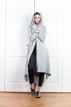 "Wool Cape, Knit Cardigan, Cloak with Hood This asymmetrical and modern cloak with hood has two side pockets, super comfy hood and thumb holes for a fabulous look. The model in the picture is 168cm. ⅼ 5.6 ft. tall and is wearing size S / color: light gray 🌟 INFO: * Worldwide EXPRESS shipping - please provide a phone number for shipping documents * US Sizing XS to 4XL - body size chart available below * We offer customization to Personal Measurements & Larger Sizes 5XL, 6XL, 7XL .... 🌟 MATE Gray Hooded Cardigan For Spring, Oversized Hooded Cardigan For Layering, Spring Hooded Cardigan For Layering, Gray Hooded Outerwear For Layering, Cloak With Hood, Hooded Wool Coat, Wool Cape, Hooded Cloak, Vest Women