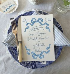 a blue and white place setting with silverware