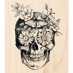 a rubber stamp with a skull and flowers on it