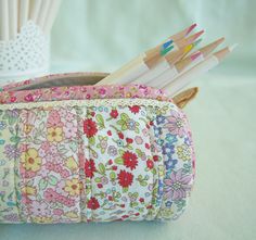 the pencils are lined up in this flowered purse