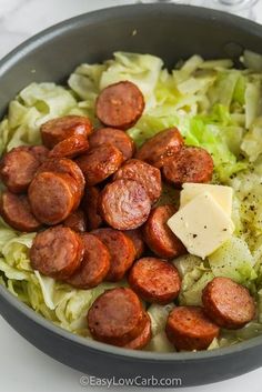 sausages, cabbage and cheese are in a bowl