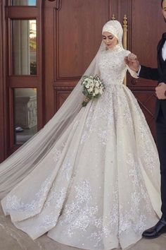 the newly married couple are posing for a photo in front of their wedding dress and veil