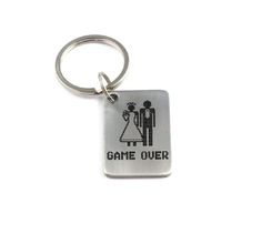 a game over keychain with an image of a bride and groom on it