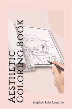 a woman's hand holding a pen and drawing an image on a book cover