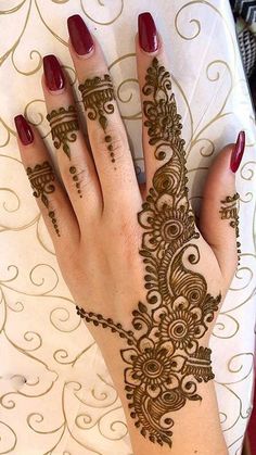 a woman's hand with henna on it