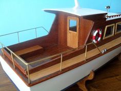 a wooden boat with a life preserver on the deck