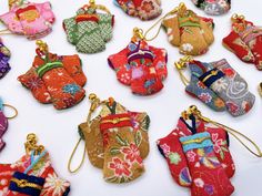 "Japanese Kimono Charm made out of Kyoto Chirimen fabric is carefully handcrafted one by one and will make a beautiful gift for any loved ones. Chirimen is a very distinctive and colorful Japanese traditional fabric that is often used to make bags and sashes that are paired with a Kimono. Each one of these charms are unique and special with different fabric designs.  How to use: 1. Take the charm off of the lobster claw attached to the strap 2. Loop the strap through your desired place 3. Clip the Kimono charm back in place - Dimensions: Approximately 2.25\"H (5\"H with strap) x 2\"W - Handmade item, the size and shape may differ slightly" Japanese Lucky Charm, Japan Gifts, Beautiful Museum, Kawaii Gifts, Fabric Designs, Charm Keychain, Traditional Fabric, Lucky Charms, Handmade Bag