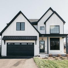 The Best Black Paint Colors For Your Home Board And Batten Siding Black And White, Exterior Gable Ideas, Charcoal Trim House Exterior, Black Windows And Doors Exterior, Exterior House Colors Black, White House Black Porch, White Windows Black Trim Exterior, White Siding Black Windows, Black House Exterior Modern