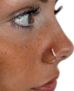 a woman with piercings on her nose