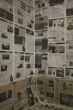 newspapers spread out on top of each other in a room with no one sitting at the table