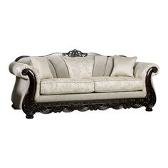 an ornately decorated couch with pillows on the armrests and back rests against a white background