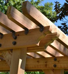 a wooden pergola with holes in it